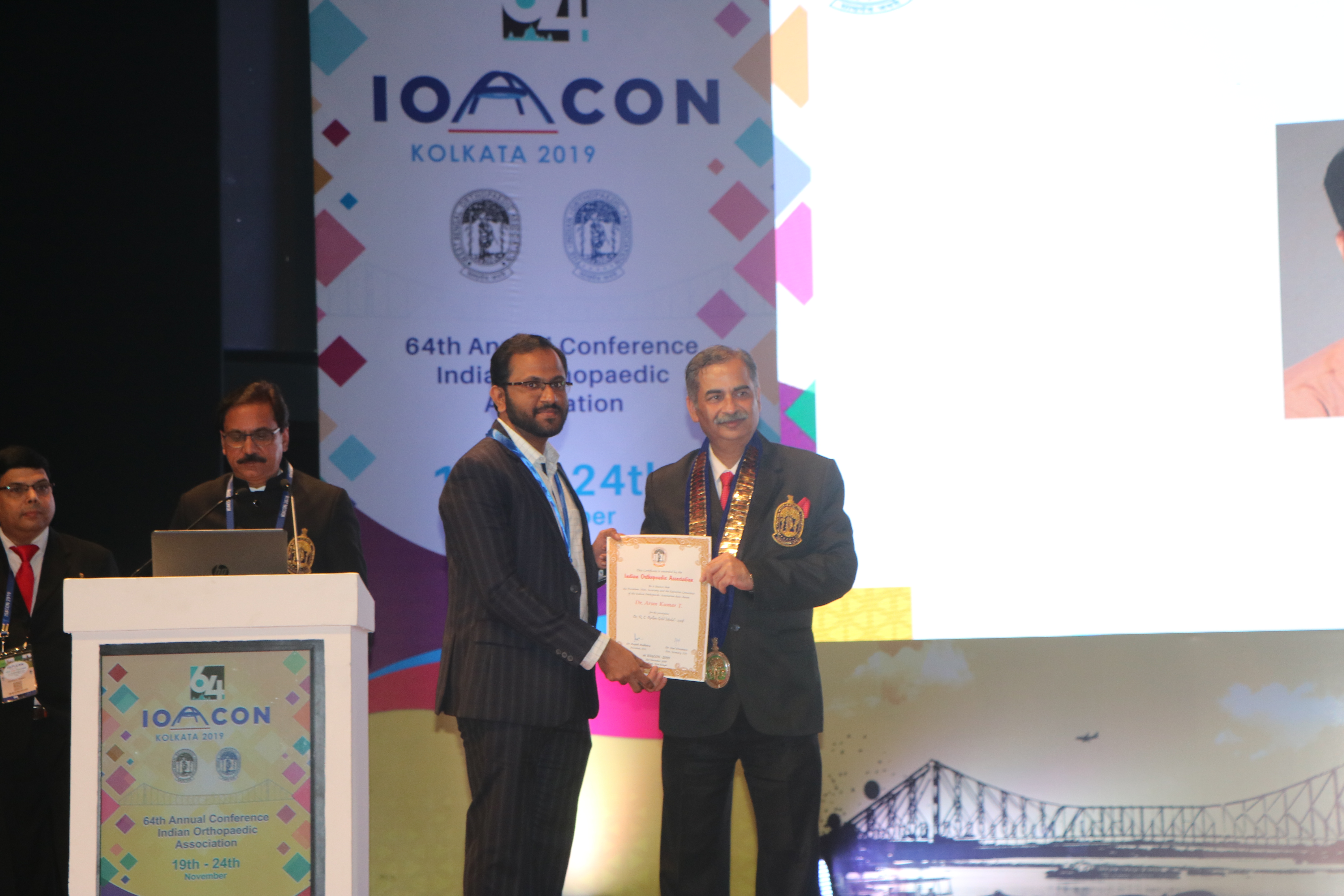 Dr. Arunkumar receiving award on stage